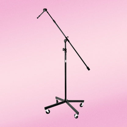 Front view of On-Stage Tripod Studio Mic Boom w/ 7" Mini Boom Extension & Casters on pink background