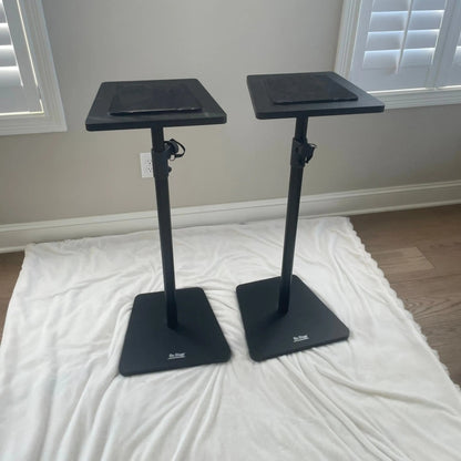 Angled view of On-Stage Wood Studio Monitor Stands (Pair) Black on white rug in room