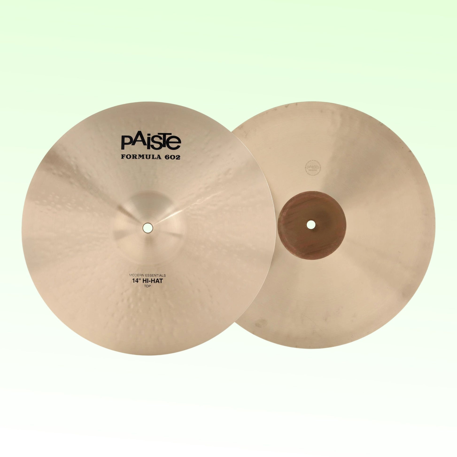 Front view of Paiste 14" Formula 602 Modern Essentials Hi-Hats on green background