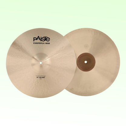 Front view of Paiste 14" Formula 602 Modern Essentials Hi-Hats on green background