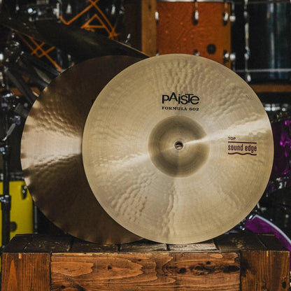 Front view of Paiste 14" Formula 602 Sound Edge Hi-Hats on wooden crate in studio