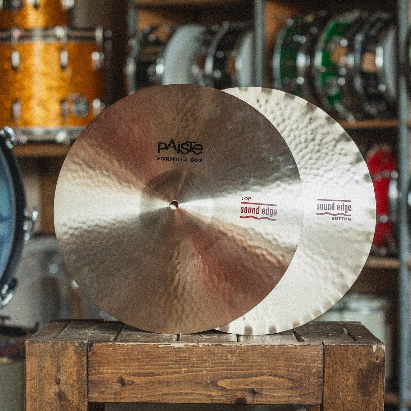 Front view of Paiste 15" 602 Sound Edge Hi-Hats on wooden crate in studio