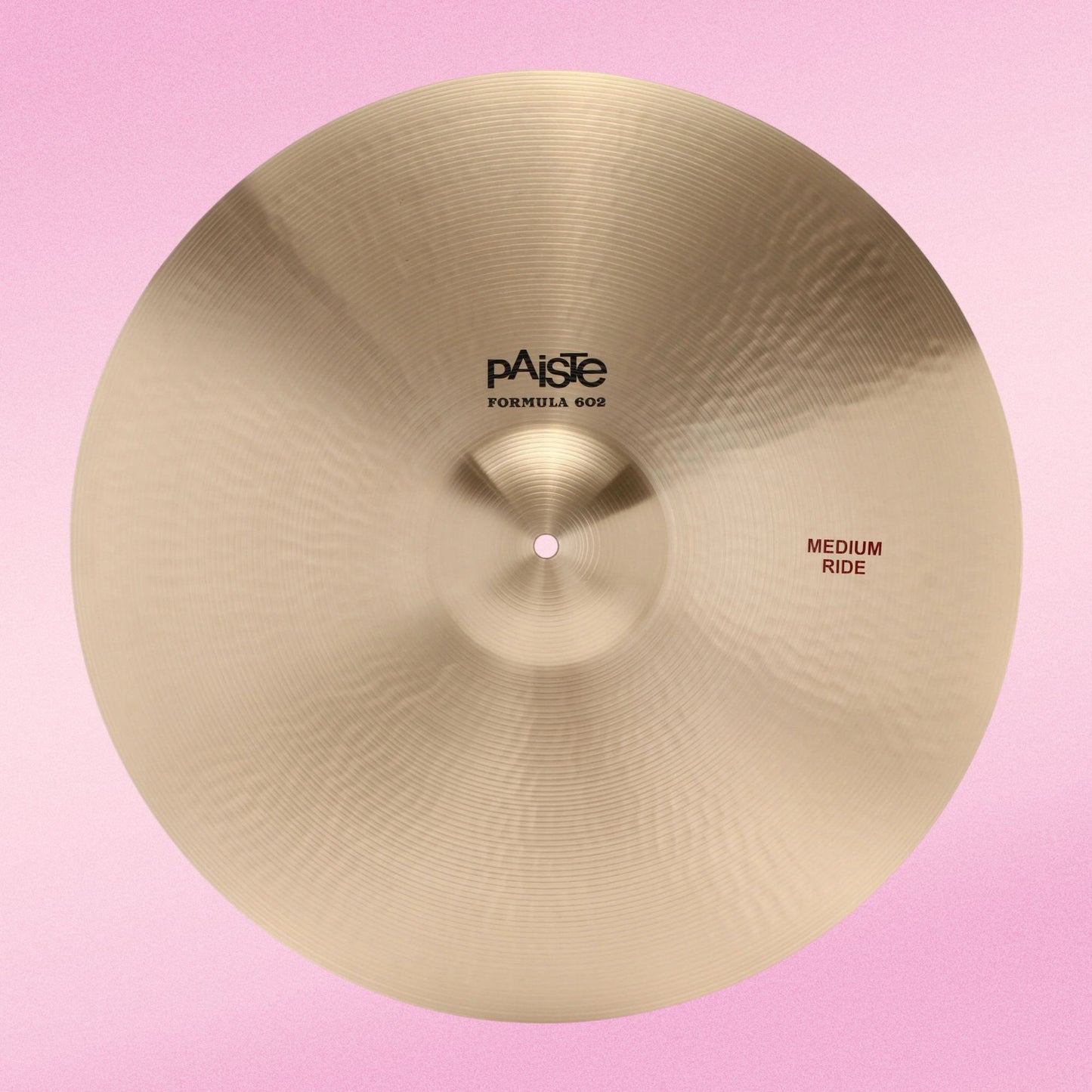 Front view of Paiste 20" Formula 602 Medium Ride Cymbal on pink background