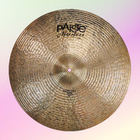 Front view of Paiste 20" Masters Dark Dry Ride Cymbal on pink and yellow background