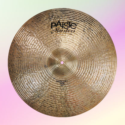 Front view of Paiste 20" Masters Dark Dry Ride Cymbal on pink and yellow background