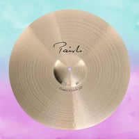 Front view of Paiste 20" Signature Power Crash Cymbal on blue and pink background