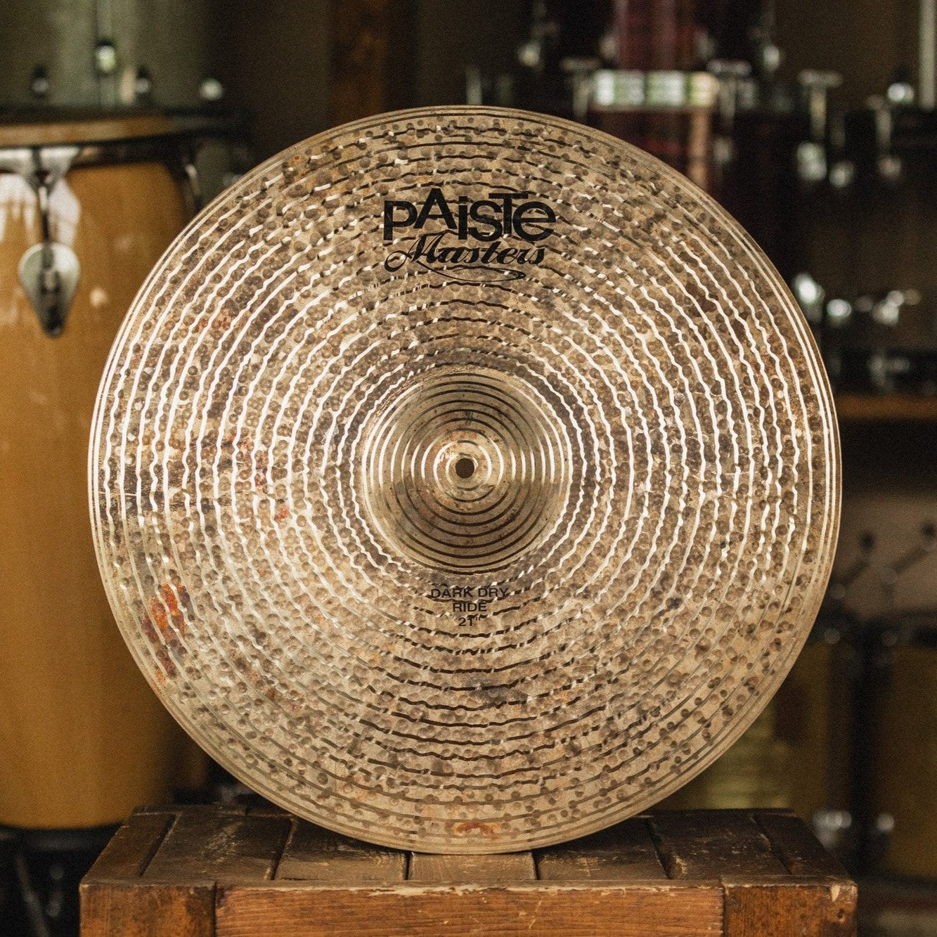 Front view of Paiste 21" Masters Dark Dry Ride Cymbal on top of wooden crate in studio