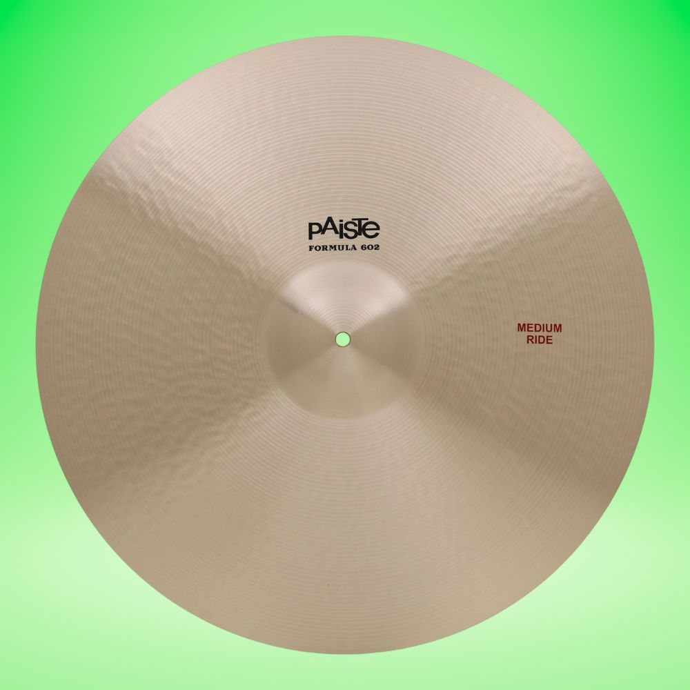 Front view of Paiste 22" Formula 602 Medium Ride Cymbal on green background