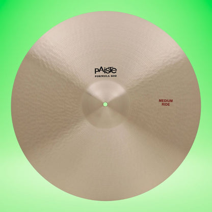 Front view of Paiste 22" Formula 602 Medium Ride Cymbal on green background