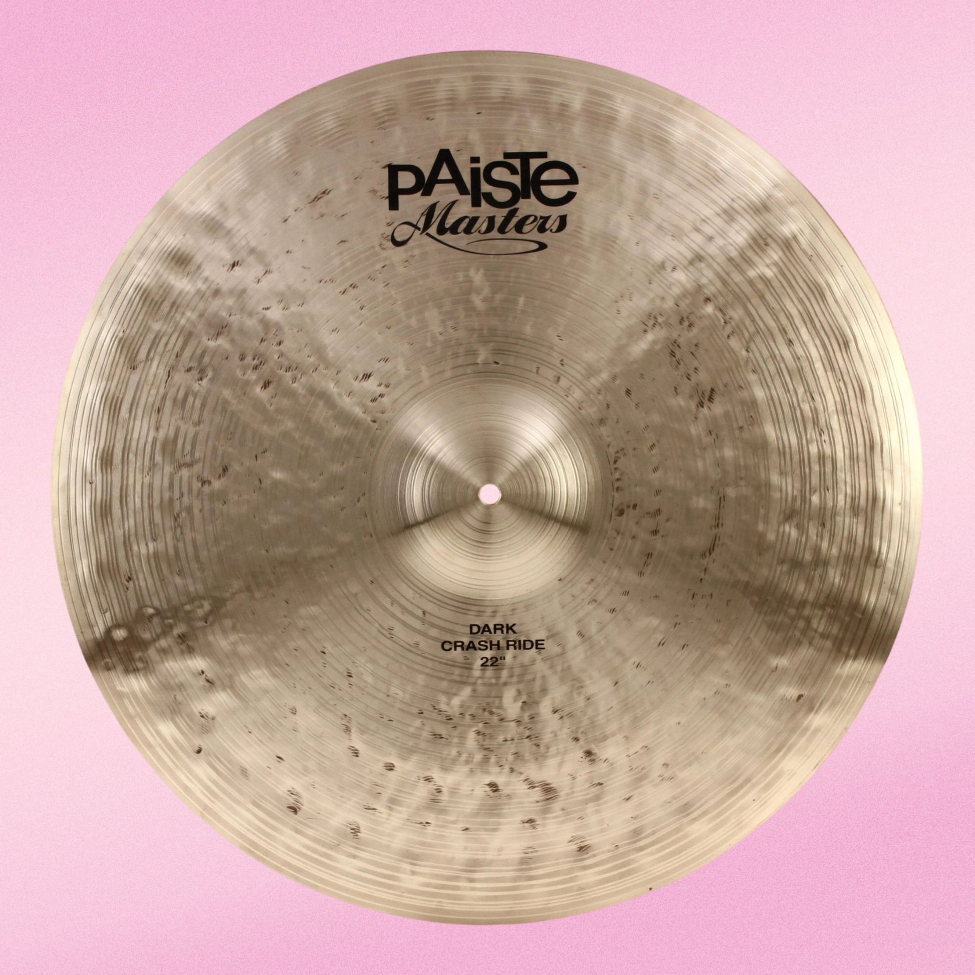 Front view of Paiste 22" Masters Dark Crash Ride Cymbal on pink background