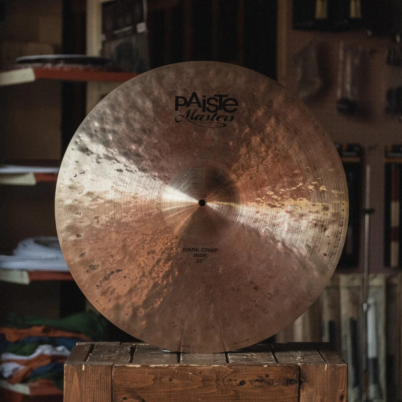 Front view of Paiste 22" Masters Dark Crisp Ride Cymbal on wooden crate in studio
