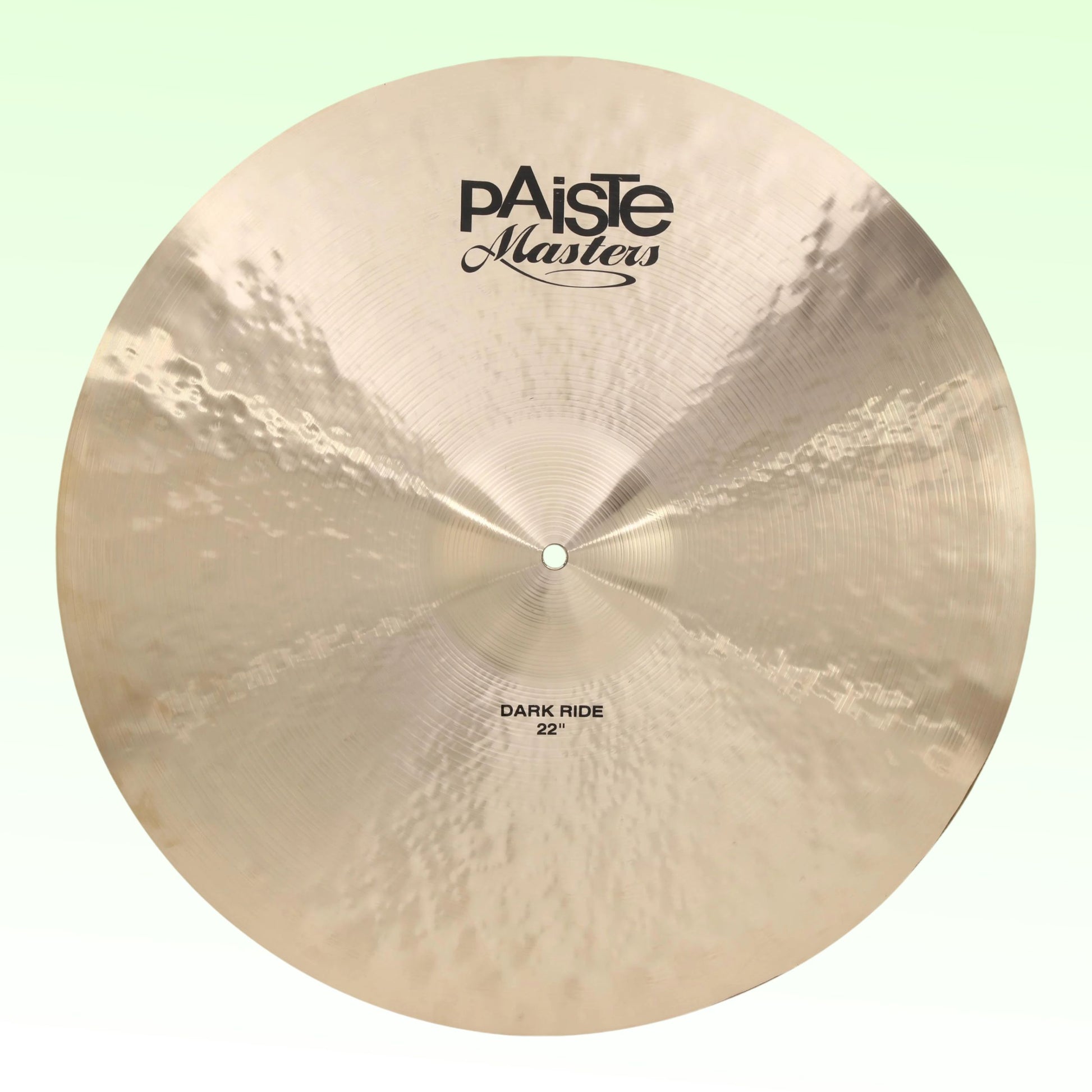 Front view of Paiste 22" Masters Dark Ride Cymbal on green background