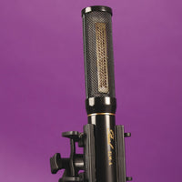 Close up view of Pearl Microphone Labs ELM-A on mic stand on purple background