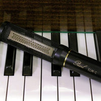 Close up view of Pearl Microphone Labs ELM-C Single Microphone on top of piano