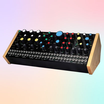Angled front view of Pittsburgh Modular Taiga Paraphonic Modular Synthesizer on multicolored background