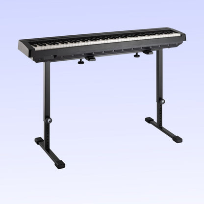Angled front view of Profile KB-STAND Fully Adjustable Keyboard Stand Black with keyboard on top on purple background