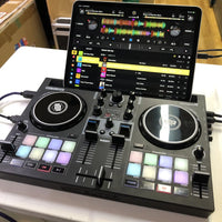 Angled view of Reloop Buddy Compact 2-Deck DJ Controller with iPad mounted