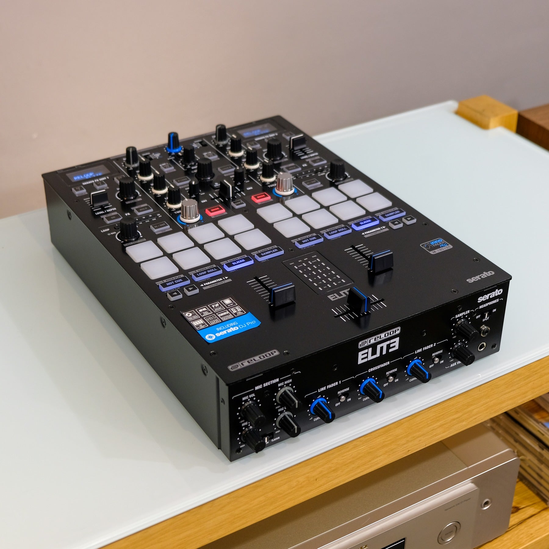 Angled view of Reloop ELITE High Performance DVS Mixer for Serato on top of white table in studio