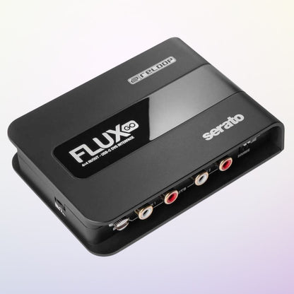 Angled view of Reloop Flux Go USB-C DVS Interface for Serato DJ Pro on purple gradient background