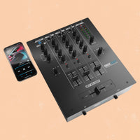 Angled front view of Reloop RMX-30 BT 3-Channel Bluetooth DJ Mixer with phone beside it on orange background
