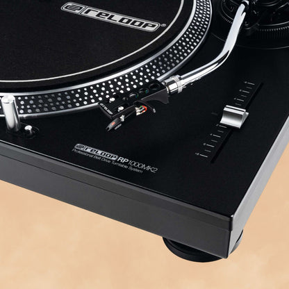 Close up view of Reloop RP-1000 MK2 Belt-Drive Turntable System on orange background