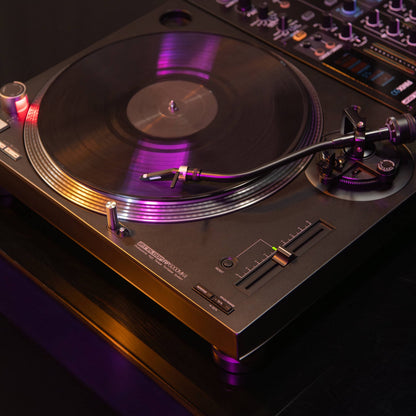 Angled view of Reloop RP-5000 MK4 Professional High-Torque Turntable System attached to DJ mixer in studio