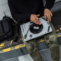 DJ using the Reloop SPiN Portable Turntable System outdoor