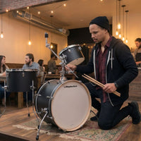 Drummer setting up the Rhythm Tech SessionGo Drum Kit in cafe