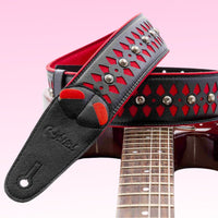 Curled view of RightOn Armour Red on top of electric guitar with pink background