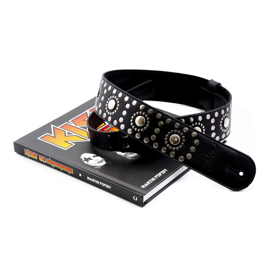 RightOn Legend Thunderstruck Guitar Strap on top of KISS book on white background