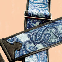 Close up view of RightOn Paisley Velvet Guitar Strap Blue on peach background