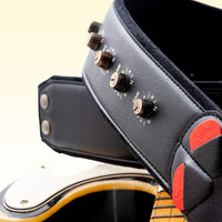 Close up view of RightOn Spinal Tap Guitar Strap knobs on top of guitar with yellow background