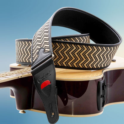 Close up view of RightOn Victoria Guitar Strap on top of acoustic guitar with blue background