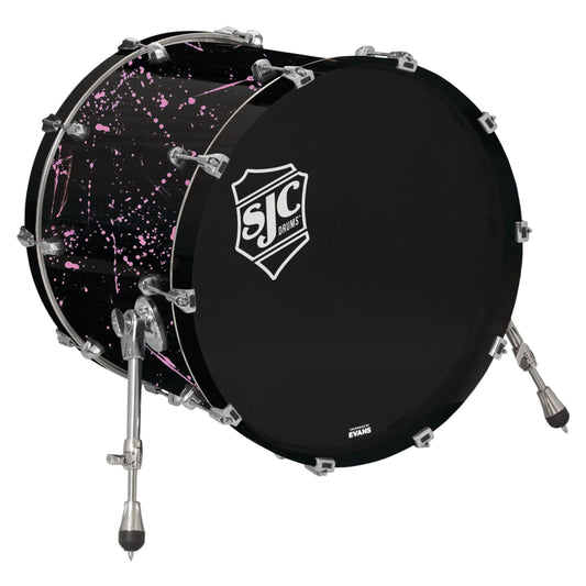 Angled view of SJC Drums Navigator 18" x 22" Bass Drum Black with Pink Splatter on white background