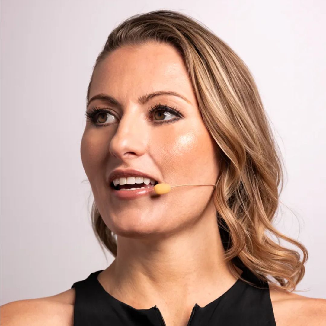 Woman with a microphone headset against a plain background