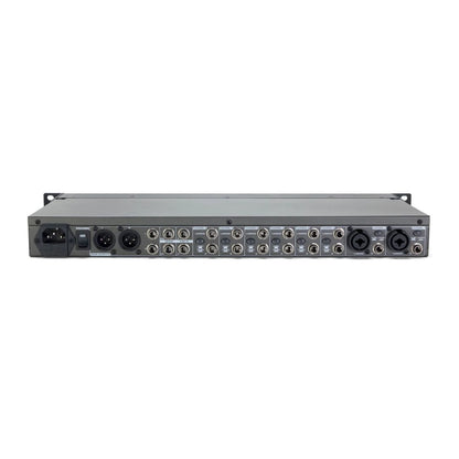 Back view of a audio rack with multiple inputs and outputs on a white background