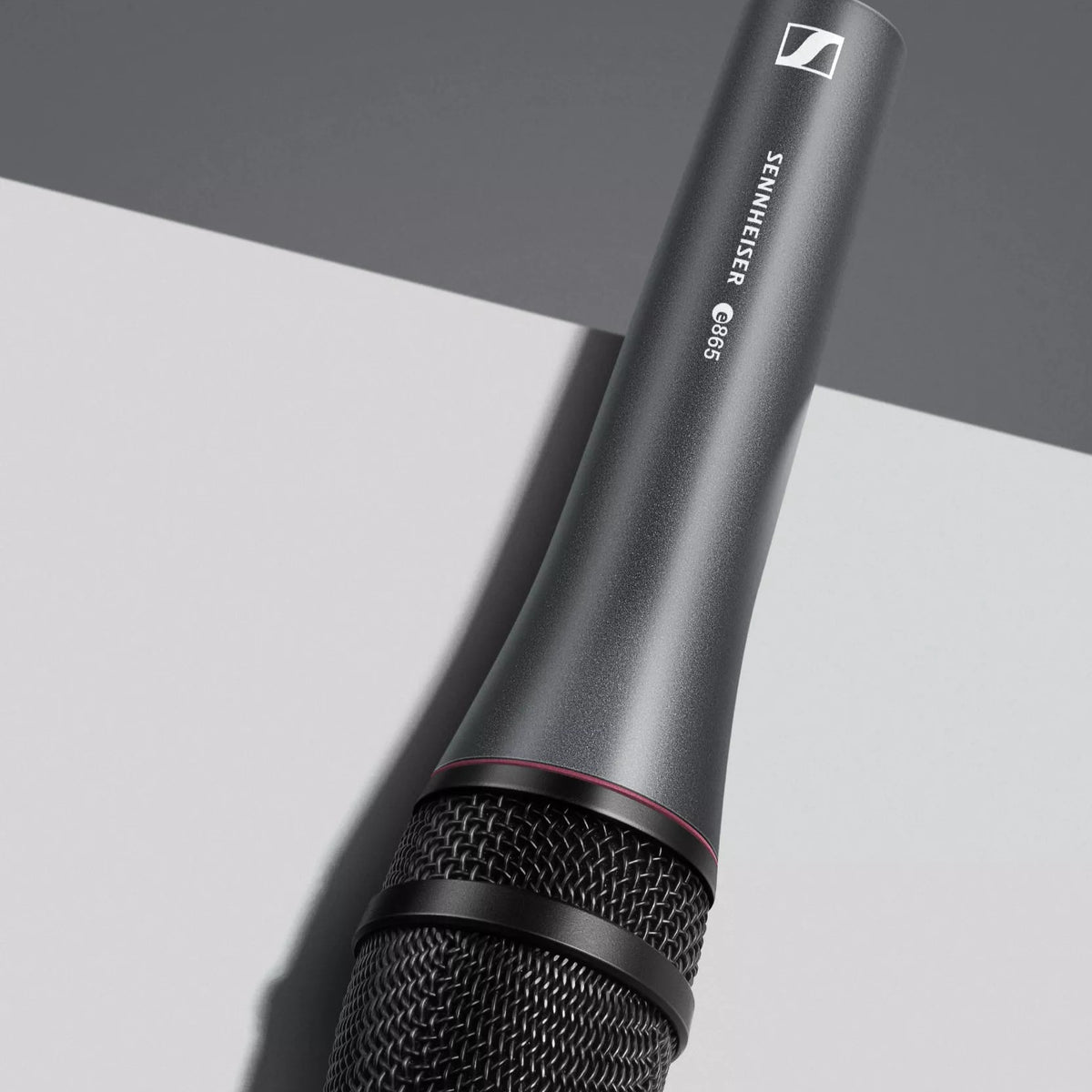 Angled view of Sennheiser e 865 Condenser Vocal Microphone on top of grey surface in studio