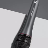 Angled view of Sennheiser e 865 Condenser Vocal Microphone on top of grey surface in studio