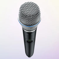 Angled top view of Shure GLXD2+/B87A Digital Wireless Dual Band Handheld Transmitter on purple background