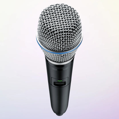 Angled top view of Shure GLXD2+/B87A Digital Wireless Dual Band Handheld Transmitter on purple background