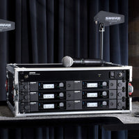 Front view of Shure GLXD+FM Dual-Band Wireless Frequency Manager mounted in a wireless microphone system rack in studio