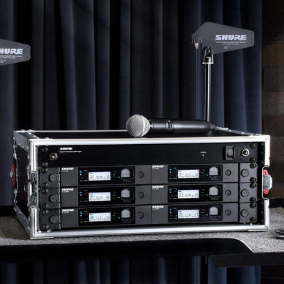 Front view of Shure GLXD+FM Dual-Band Wireless Frequency Manager mounted in a wireless microphone system rack in studio