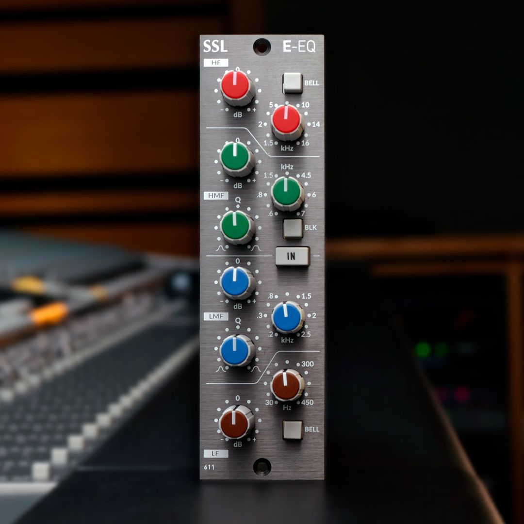 Front view of Solid State Logic E-Series EQ Module 500 Series on top of mixing console in studio