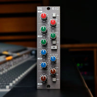 Front view of Solid State Logic E-Series EQ Module 500 Series on top of mixing console in studio