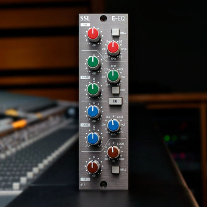 Front view of Solid State Logic E-Series EQ Module 500 Series on top of mixing console in studio