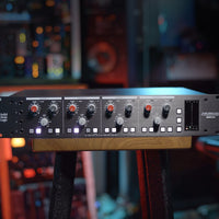 Front view of Solid State Logic PUREDRIVE QUAD 4-Channel Preamplifier on top of stool in studio