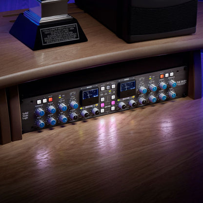 Angled front view of Solid State Logic THE BUS+ 2-Channel Bus Compressor and Dynamic EQ on mixing desk in studio