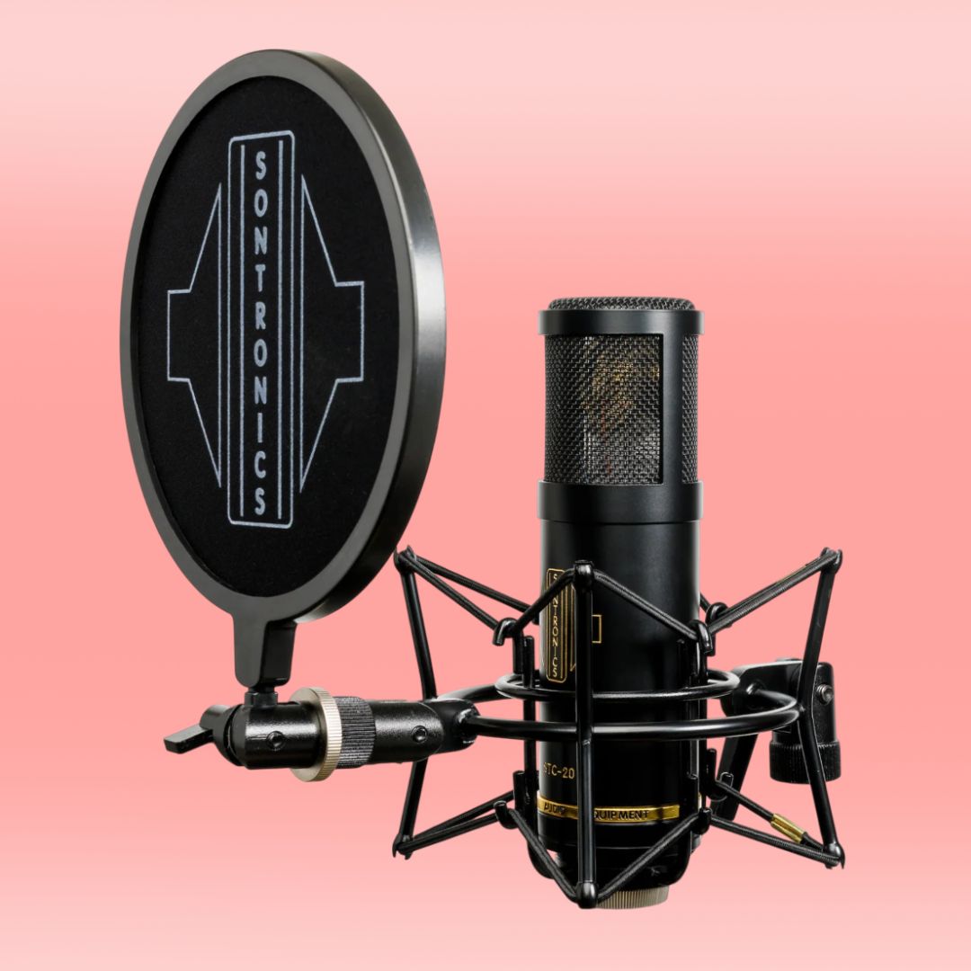 Angled front view of Sontronics STC-20 Large-Diaphragm Condenser Microphone on shockmount with windscreen on pink background