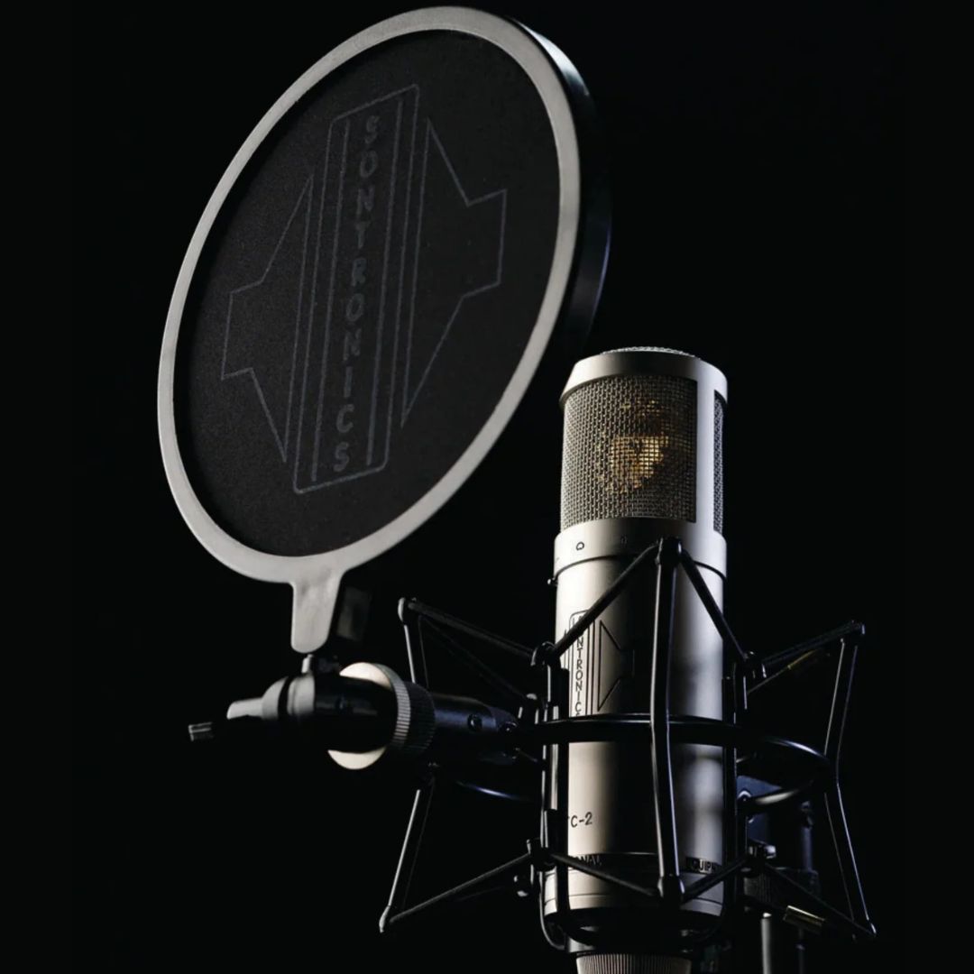 Angled view of Sontronics STC-2 Microphone Silver with windscreen on black background