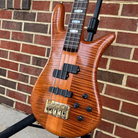 Angled close up front view of Spector Euro 4 DW Doug Wimbish Signature Bass Guitar Amber Stain Gloss with brickwall background